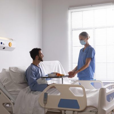 male-patient-bed-talking-nurse