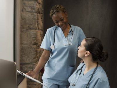 two-female-nurses-working-clinic-scrubs